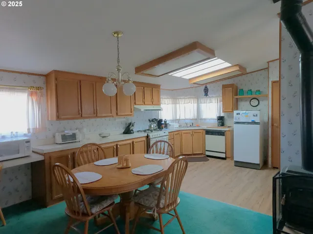 a kitchen with granite countertop a sink and cabinets