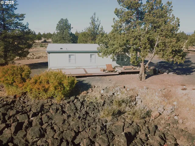 a view of a yard with wooden fence
