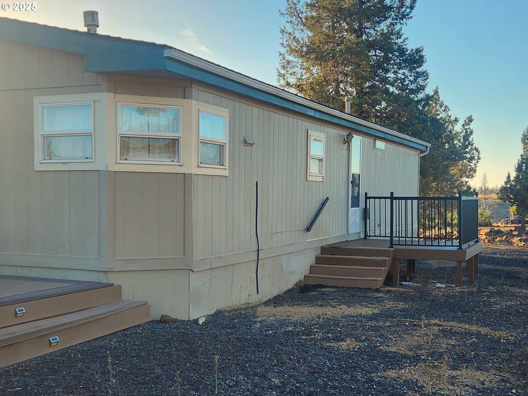 12705 Southwest Airfield Lane Culver, OR 97734 - Photo 4 of 20 a view of backyard with wooden fence and large trees