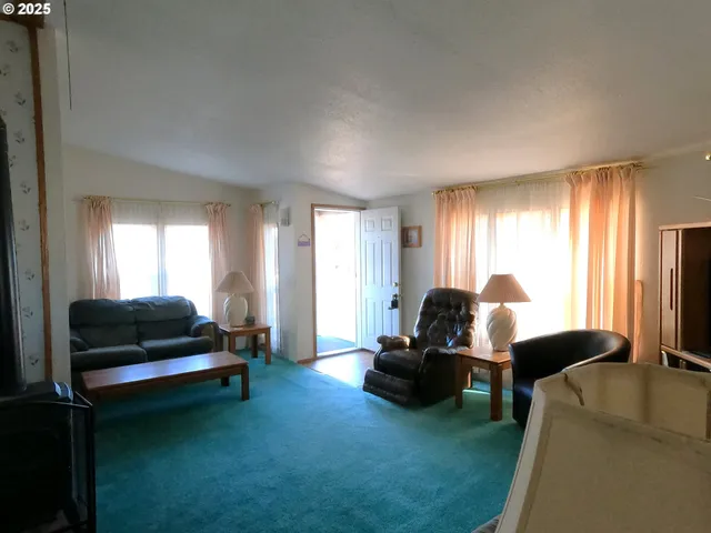 a living room with furniture and a lamp