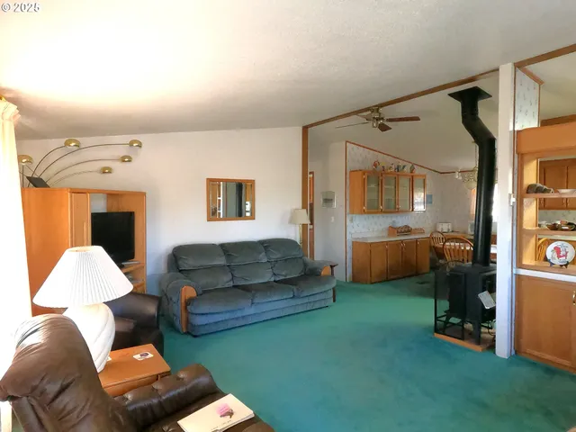 a living room with a table chair and a fireplace