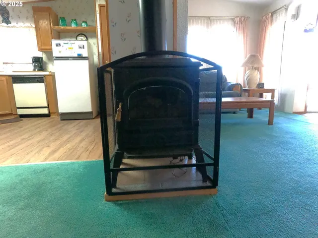 a kitchen with stainless steel appliances kitchen island granite countertop a sink cabinets and wooden floor