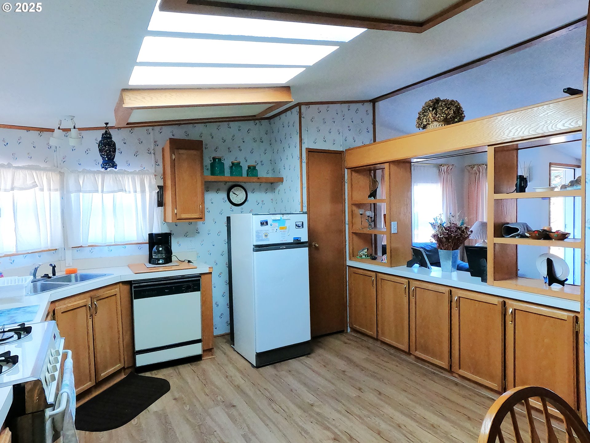 12705 Southwest Airfield Lane Culver, OR 97734 - Photo 10 of 20 a kitchen with stainless steel appliances kitchen island granite countertop a sink cabinets and wooden floor