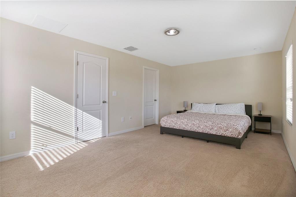 3216 Rodrick Circle Orlando, FL 32824 - Photo 12 of 33 a bedroom with a bed and a mirror