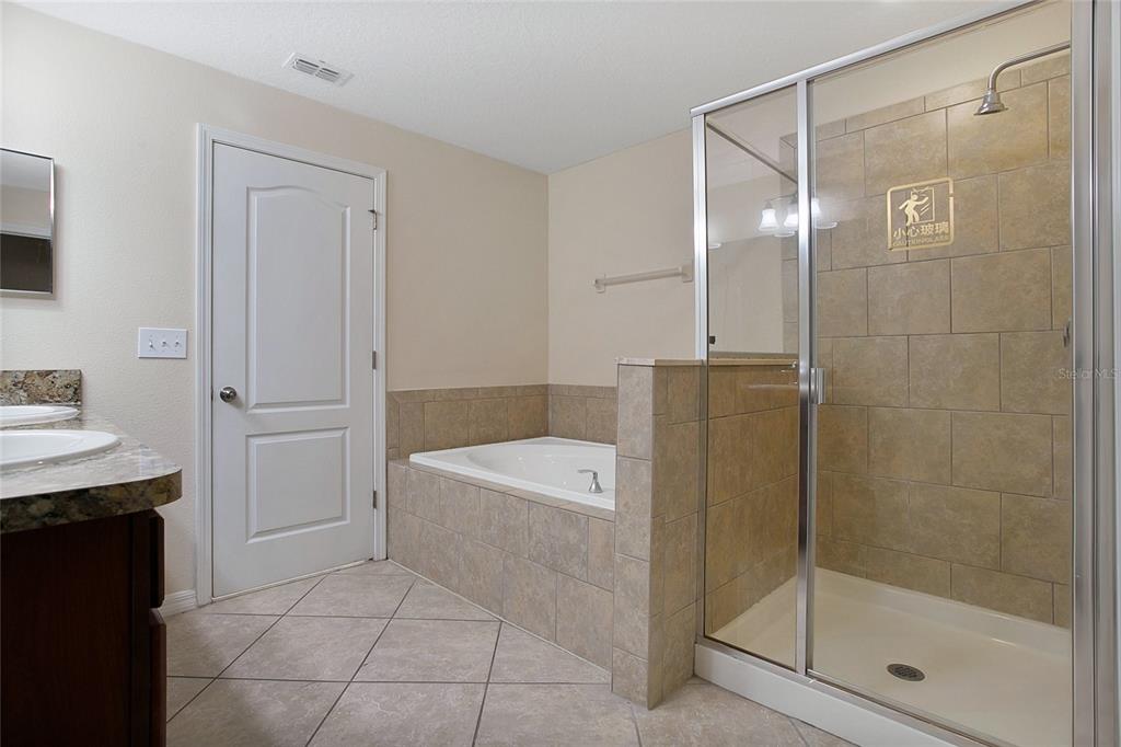 3216 Rodrick Circle Orlando, FL 32824 - Photo 14 of 33 a bathroom with a bathtub a shower a sink and mirror
