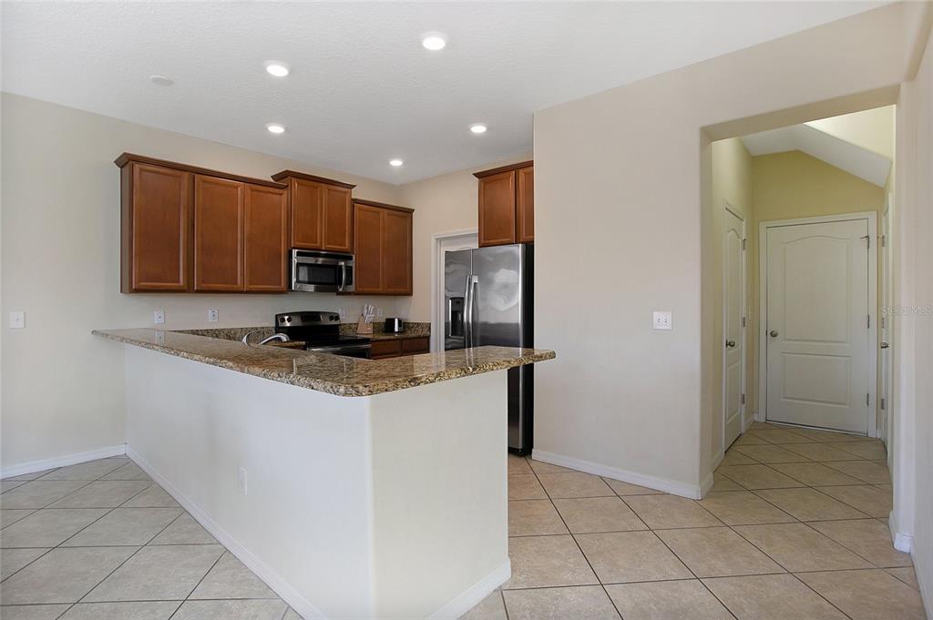 3216 Rodrick Circle Orlando, FL 32824 - Photo 7 of 33 a kitchen with stainless steel appliances granite countertop a refrigerator and a stove top oven
