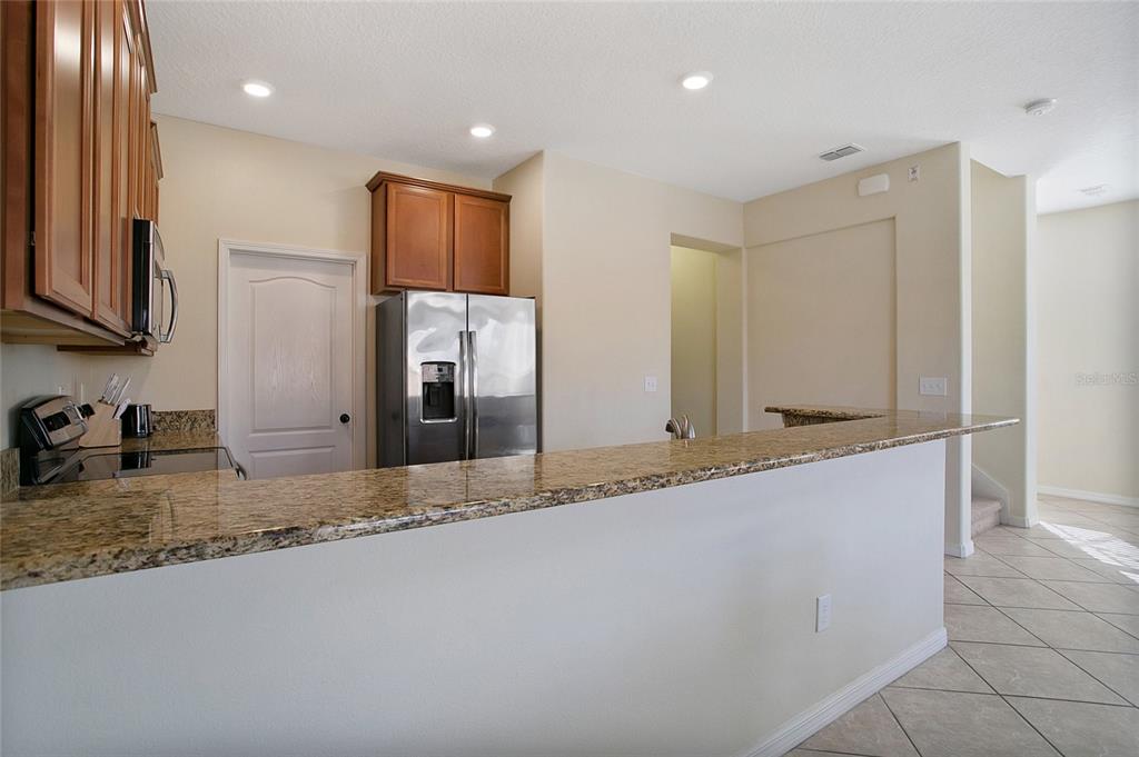 3216 Rodrick Circle Orlando, FL 32824 - Photo 9 of 33 a large bathroom with a granite countertop sink and a large mirror