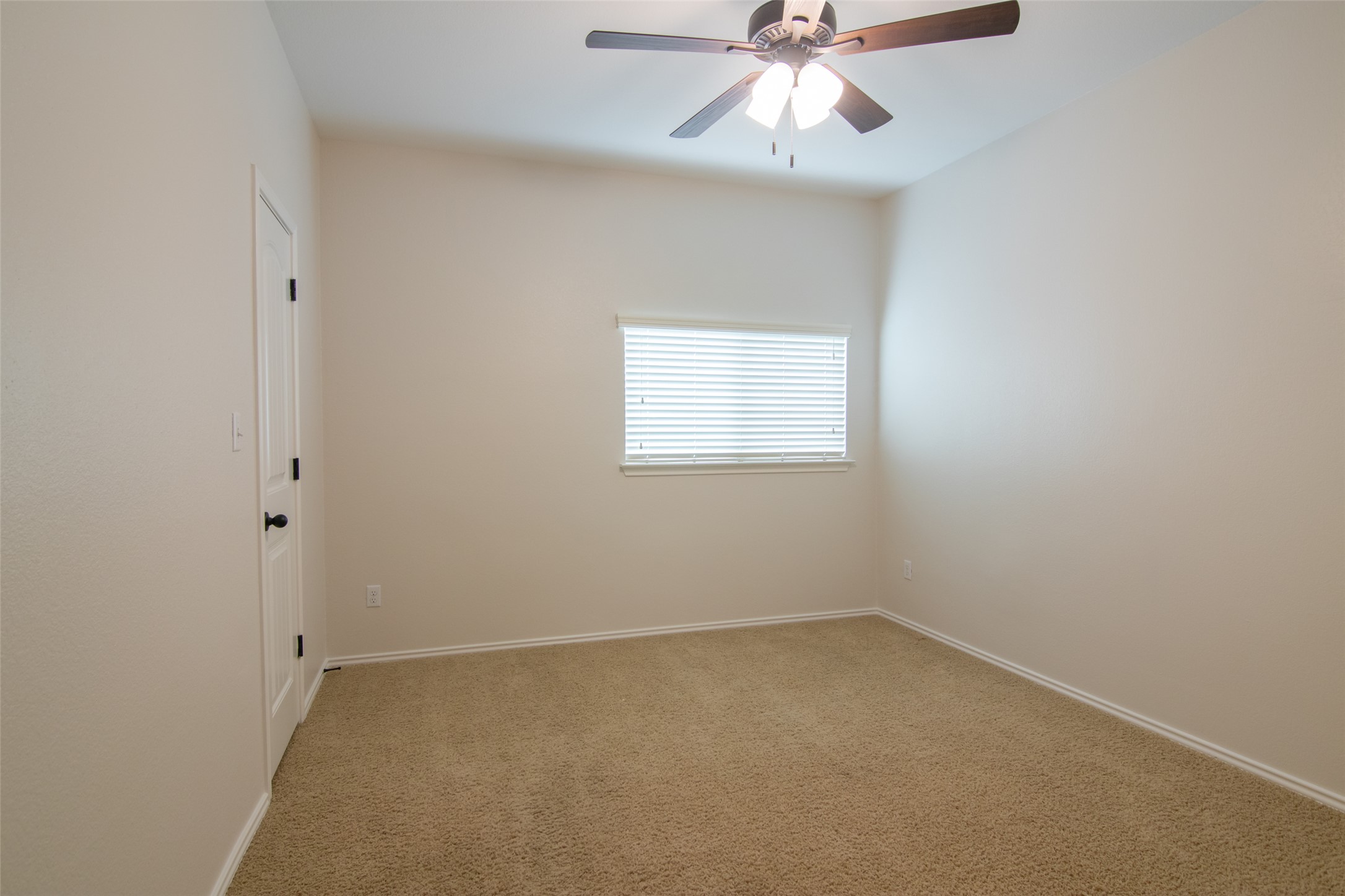 12104 Broten Street Austin, TX 78748 - Photo 25 of 32 A well-proportioned bedroom features soft carpet and a convenient ceiling fan.