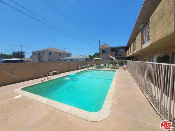a view of a swimming pool and lounge chair