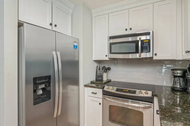 a kitchen with cabinets and stainless steel appliances