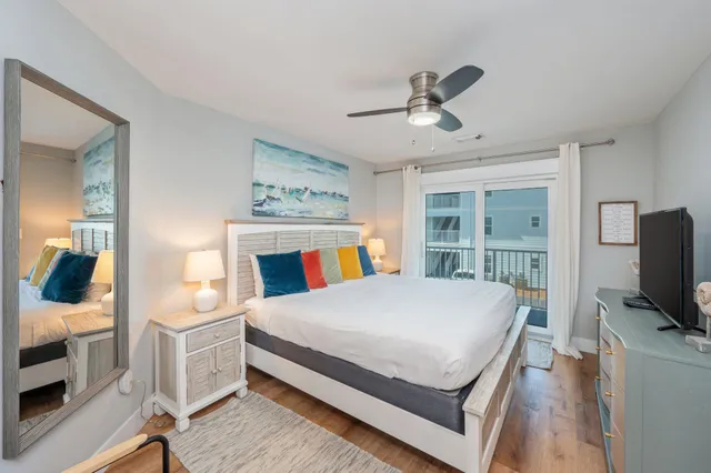 a bedroom with a bed and a flat tv screen on dresser