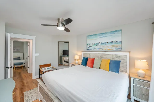 a bedroom with a large bed and a chandelier