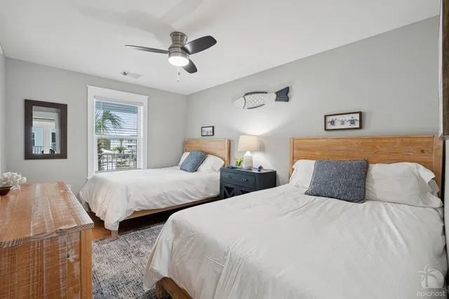 a bedroom with two beds and painting on the wall