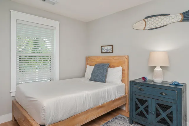 a bedroom with a bed and a lamp on table