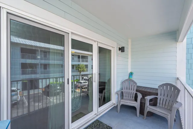 a view of a balcony with chairs