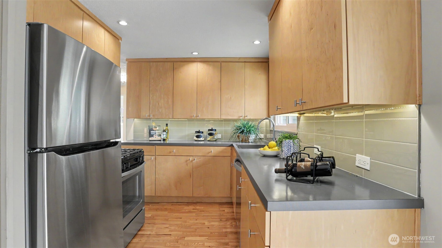 12515 Southeast 171st Street Renton, WA 98058 - Photo 11 of 24 a kitchen with stainless steel appliances a refrigerator sink and cabinets