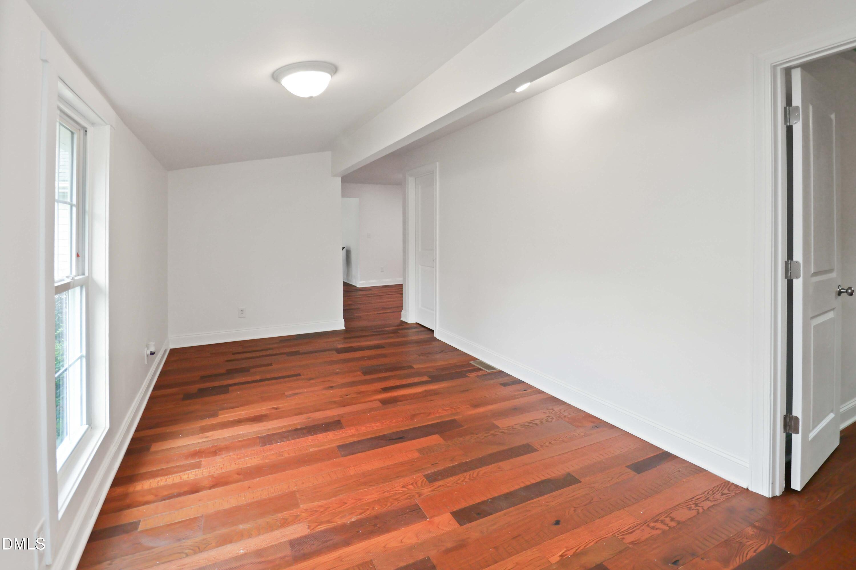 5209 Durham Road Raleigh, NC 27613 - Photo 11 of 18 a bedroom with a bed and a window