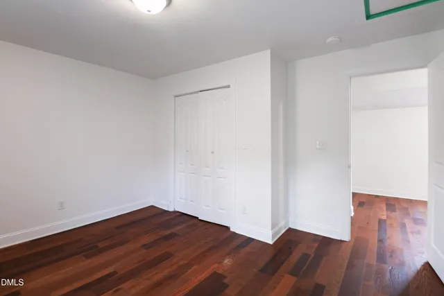 a view of a room with wooden floor