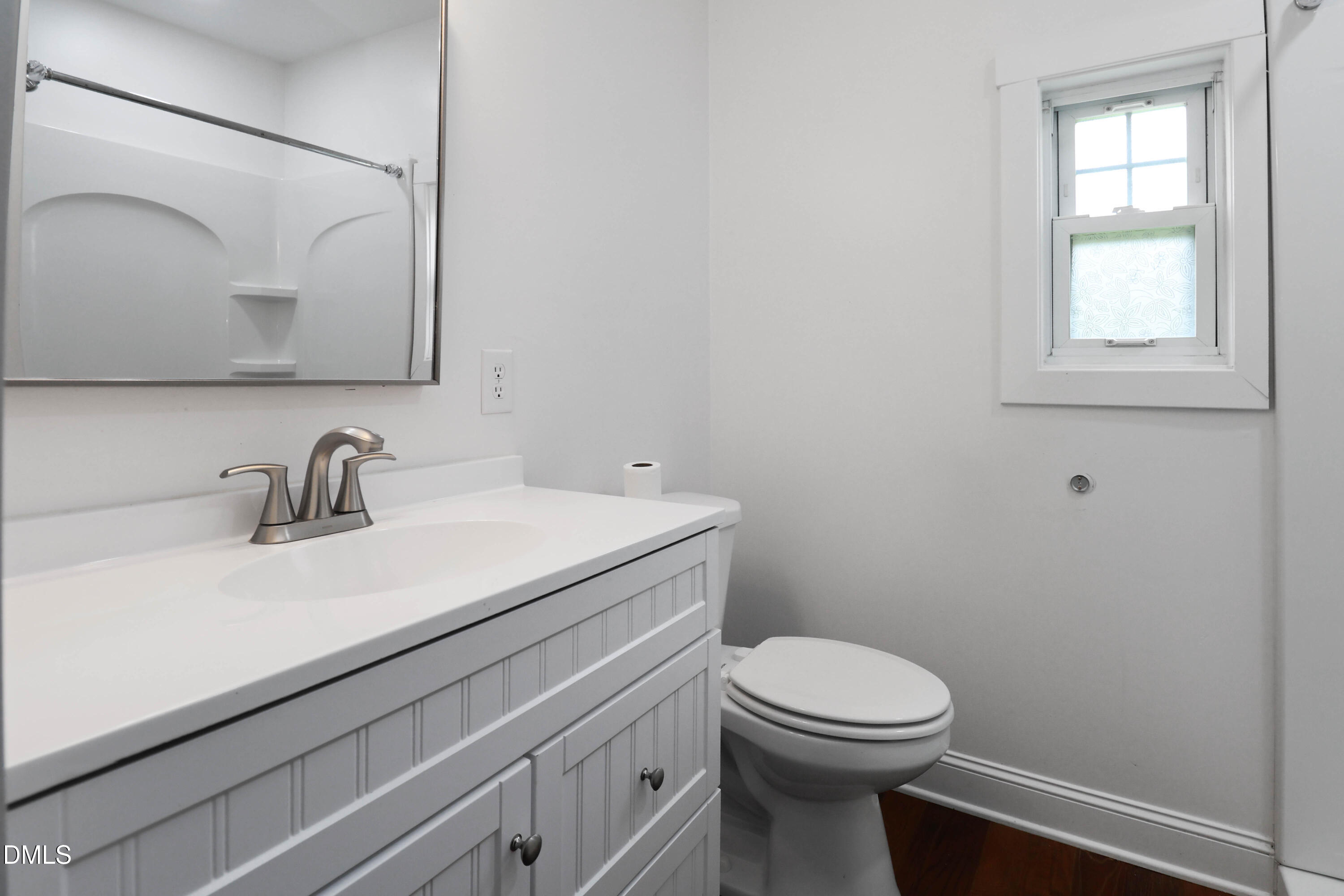 5209 Durham Road Raleigh, NC 27613 - Photo 13 of 18 a bathroom with a toilet a sink and mirror