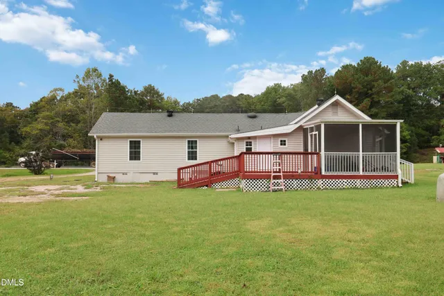 a view of a house with a yard and sitting area