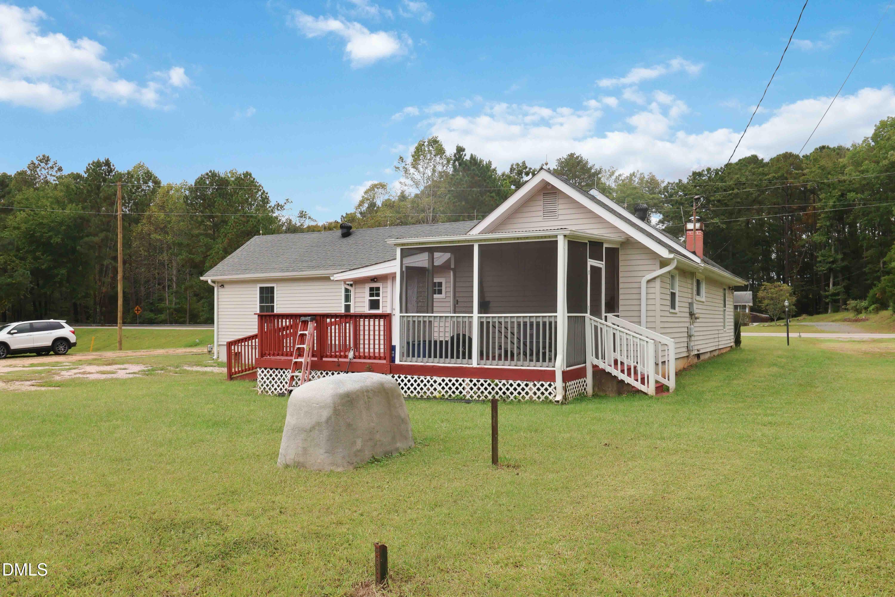 5209 Durham Road Raleigh, NC 27613 - Photo 15 of 18 a front view of a house with yard porch and sitting area