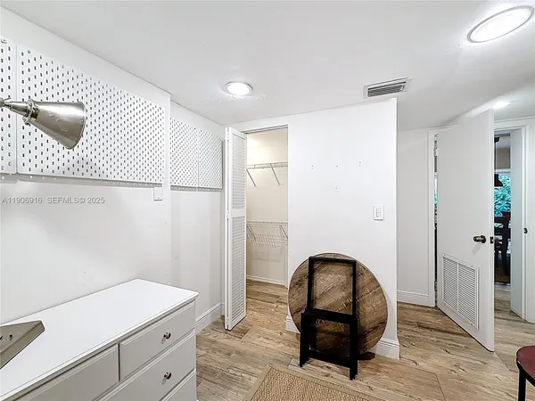 a bedroom with a bed and a mirror