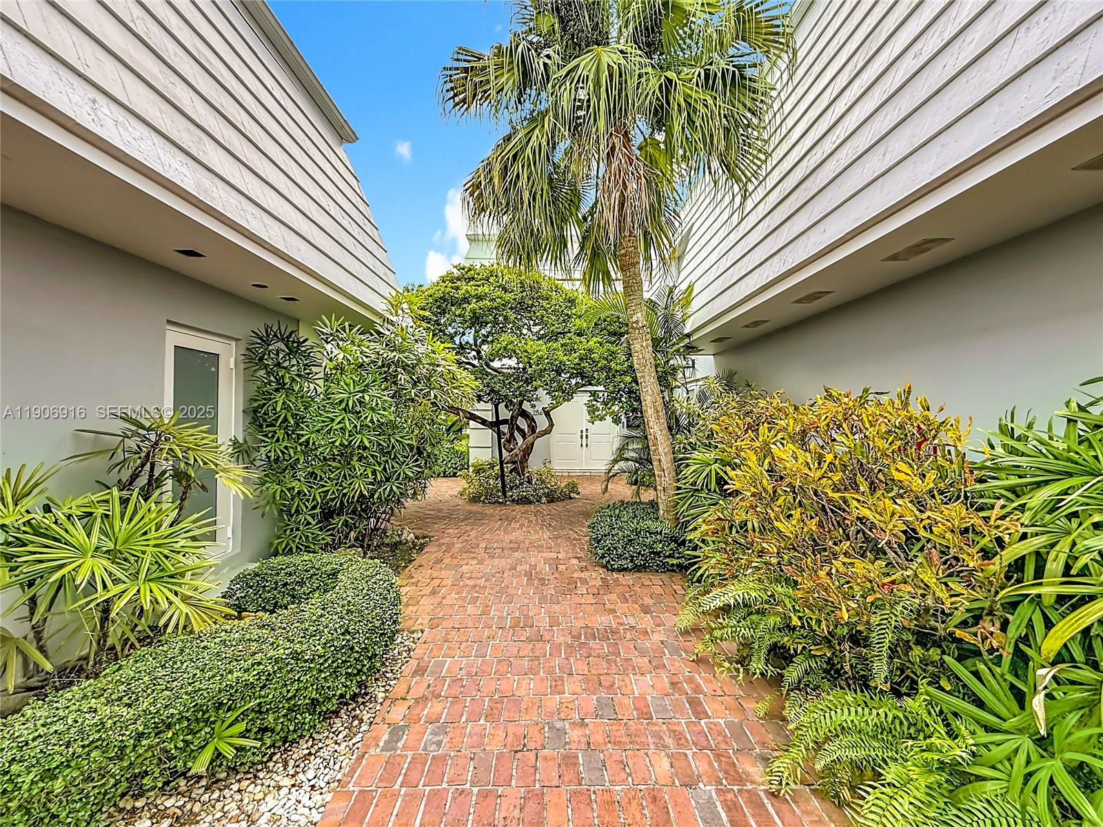 254 Seaview Drive, Unit 5 Key Biscayne, FL 33149 - Photo 2 of 30 a front view of a house with a yard