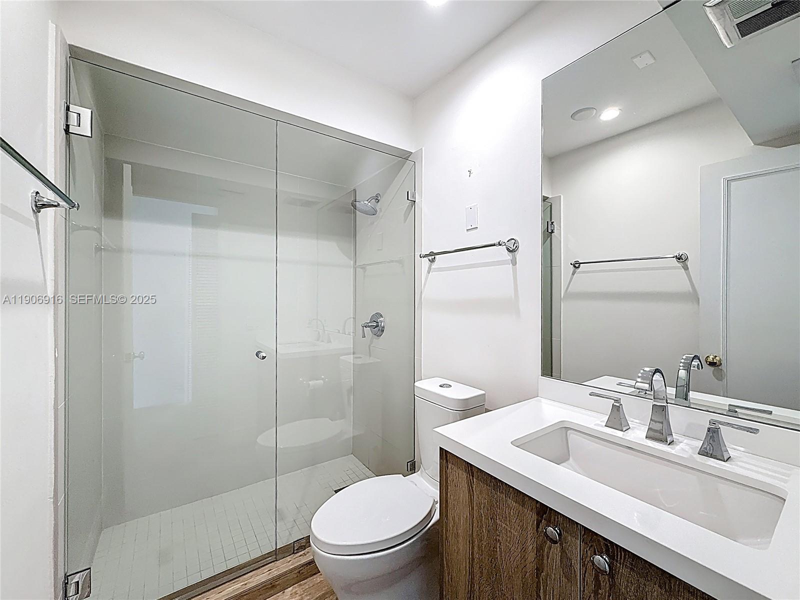 254 Seaview Drive, Unit 5 Key Biscayne, FL 33149 - Photo 21 of 30 a bathroom with a sink a toilet and shower
