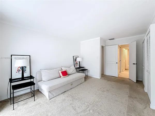 a living room with furniture and white walls