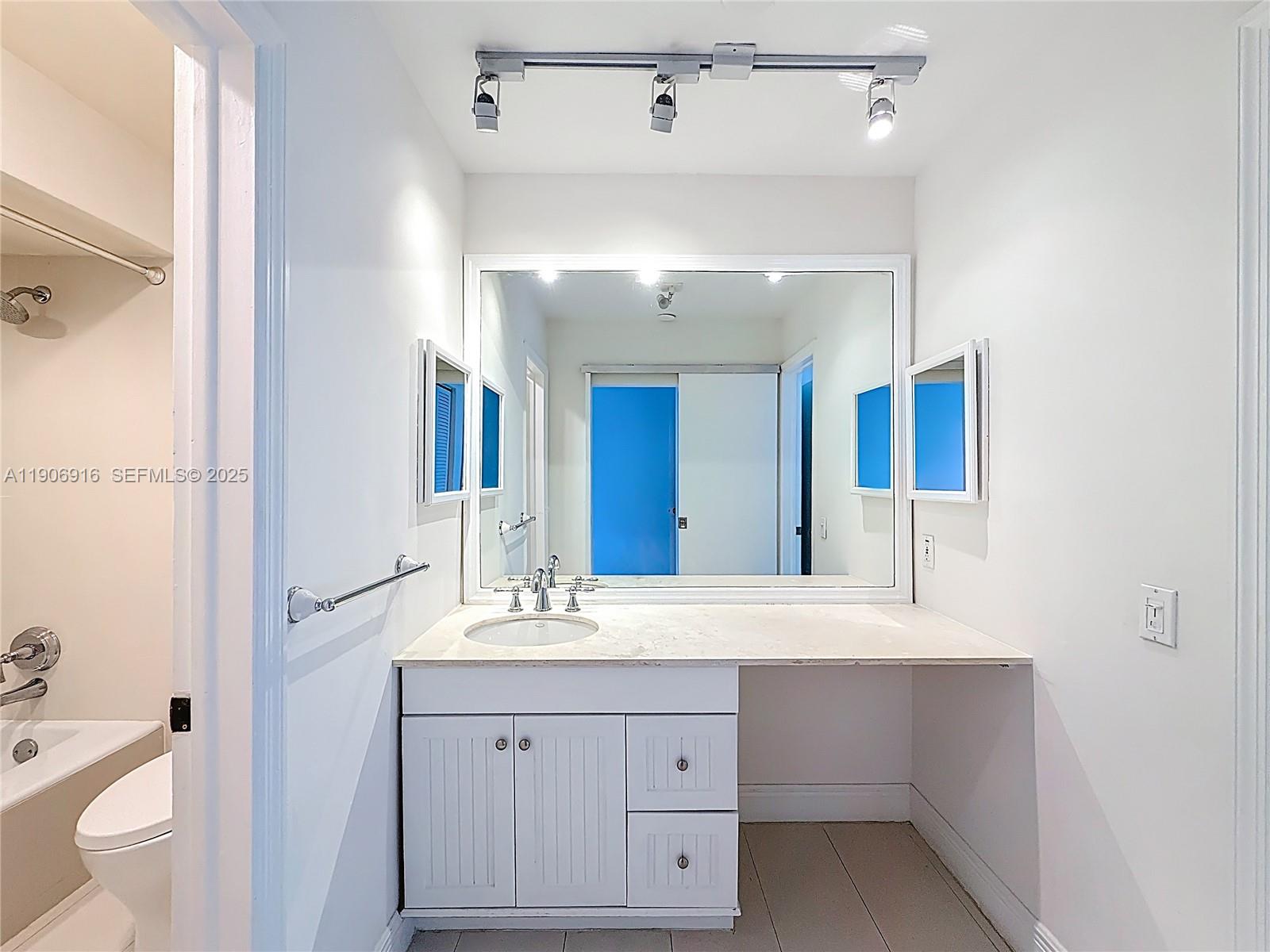 254 Seaview Drive, Unit 5 Key Biscayne, FL 33149 - Photo 26 of 30 a bathroom with a sink a toilet and a mirror