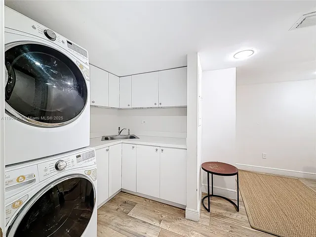 a utility room with sink dryer and washer