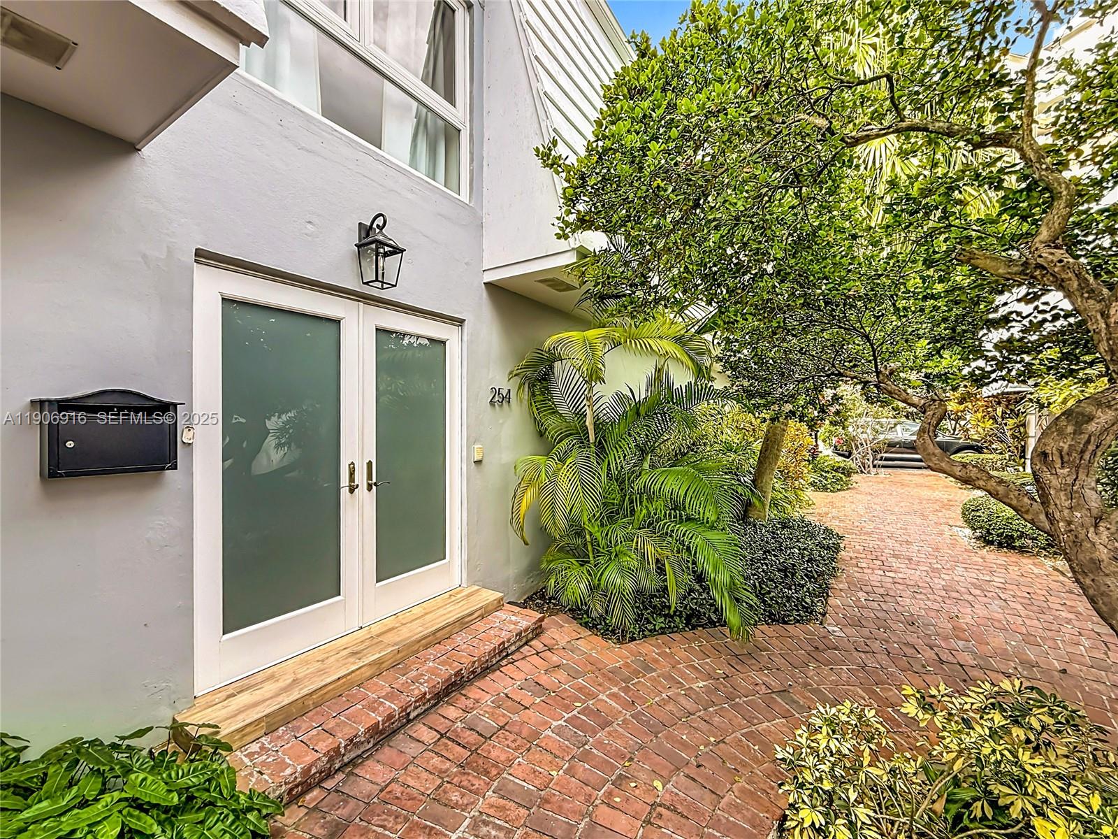 254 Seaview Drive, Unit 5 Key Biscayne, FL 33149 - Photo 3 of 30 a front view of a house with a yard