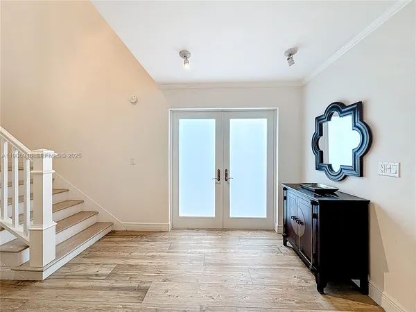 a view of a livingroom with wooden floor and staircase