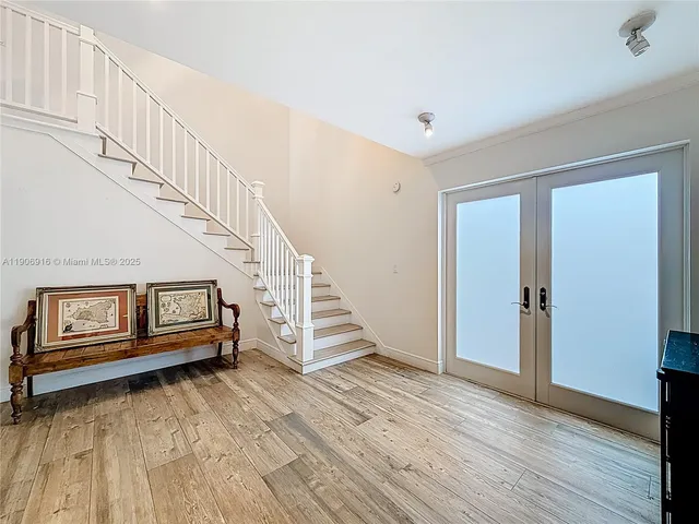 a view of entryway with wooden floor and stairs