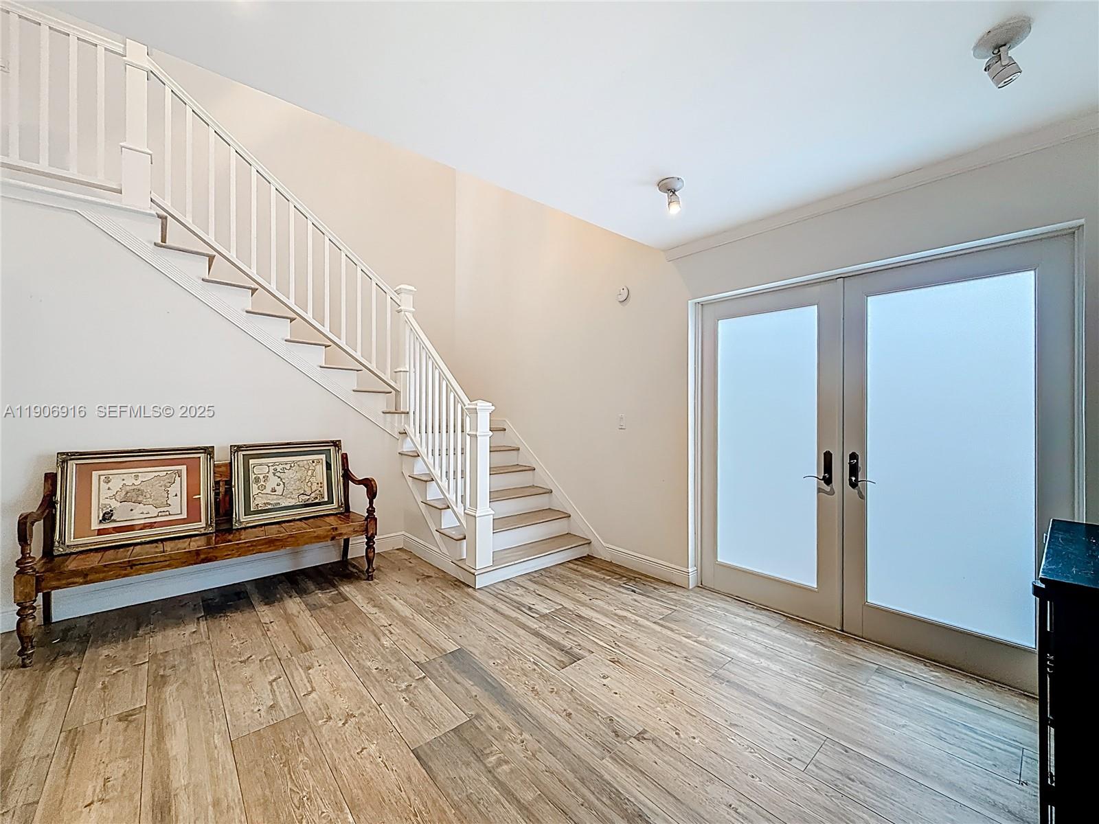 254 Seaview Drive, Unit 5 Key Biscayne, FL 33149 - Photo 5 of 30 a view of entryway with wooden floor and stairs