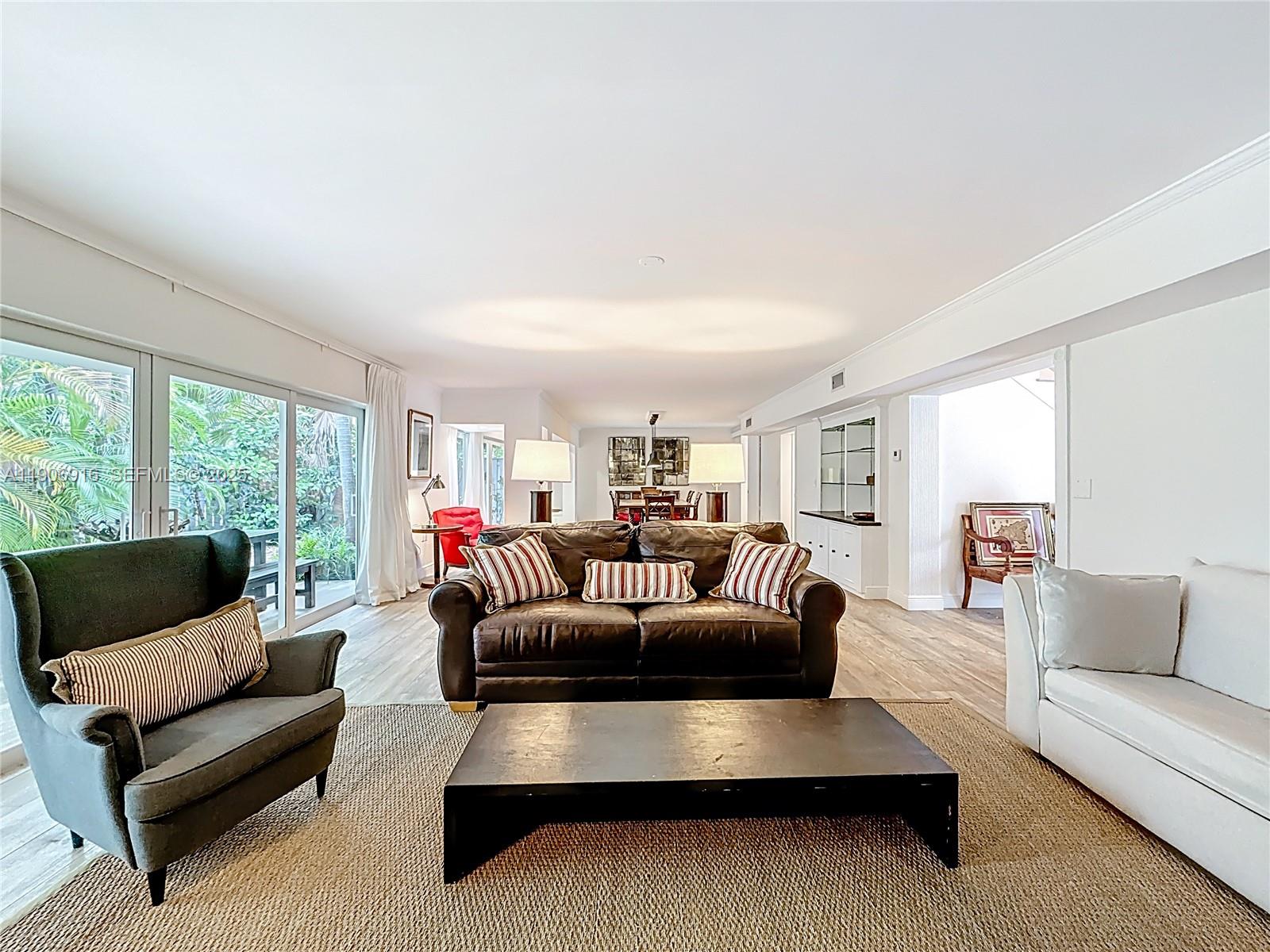 254 Seaview Drive, Unit 5 Key Biscayne, FL 33149 - Photo 8 of 30 a living room with furniture and a large window