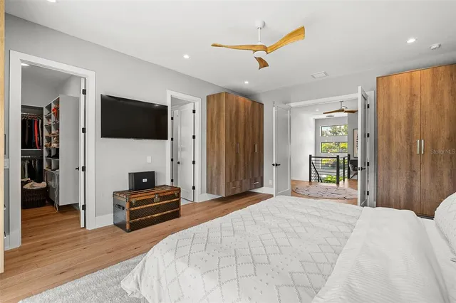 a bathroom with a tub sink double vanity mirror and window