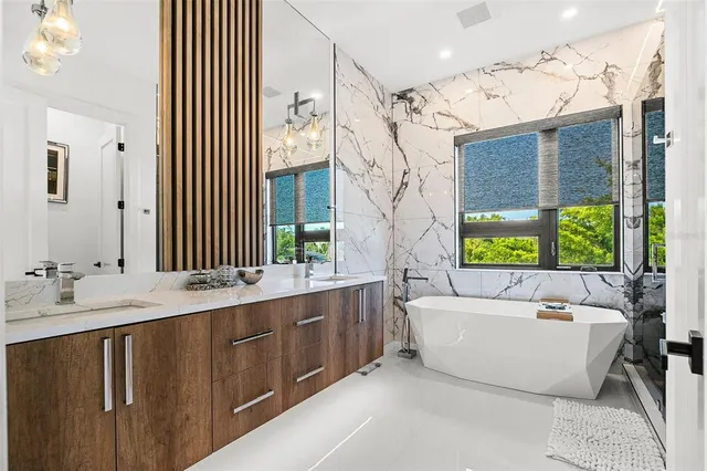 a view of bathroom with tub and shower