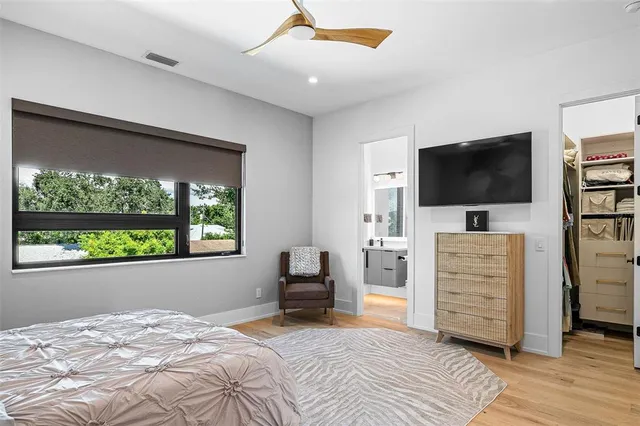 a bedroom with a bed and a flat screen tv