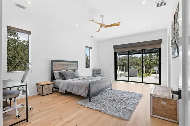 a living room with patio furniture and a potted plants