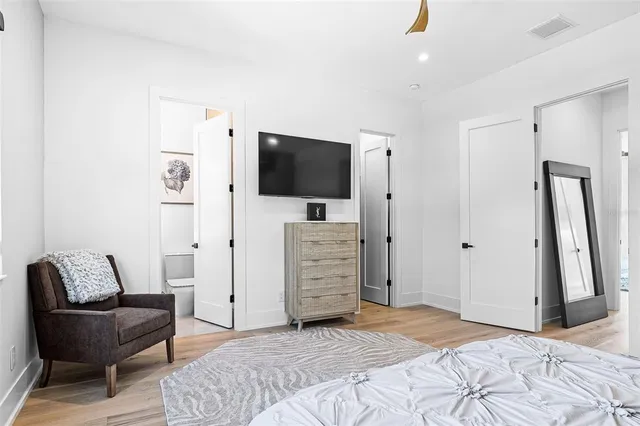 a view of swimming pool with red chairs