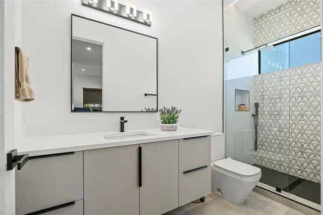 an aerial view of a house with a yard and lake view in back