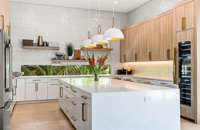 a kitchen with stainless steel appliances a sink a stove and cabinets