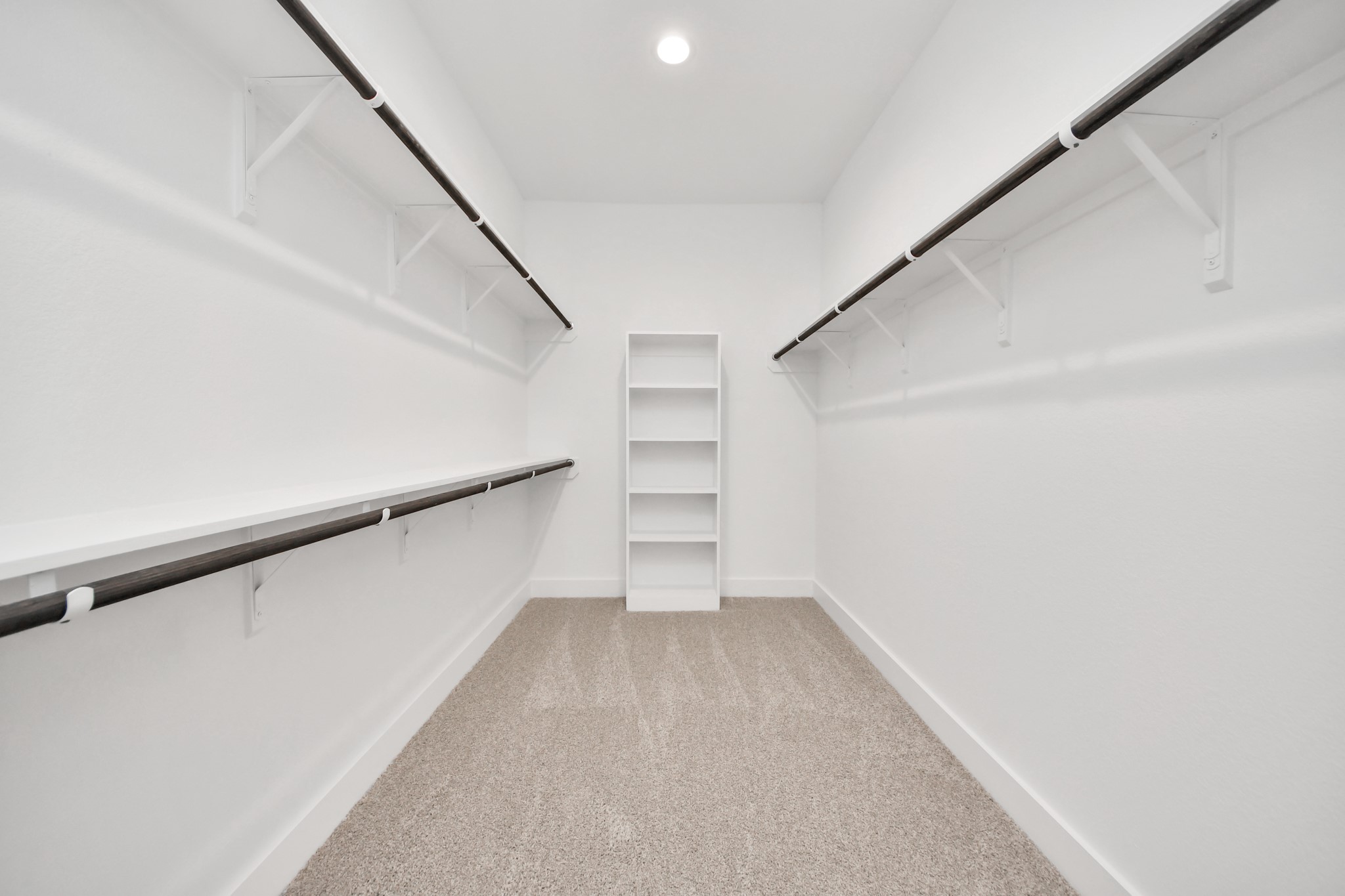 3046 Native Spg Drive Spring, TX 77373 - Photo 29 of 35 Walk-in closet that epitomizes luxury and practicality. This generously sized space features built-in shelving, offering abundant room for impeccable organization. High ceilings and recessed lighting create a bright and welcoming ambiance. Sample photo of completed home with similar floor plan. Actual colors and selections may vary.
