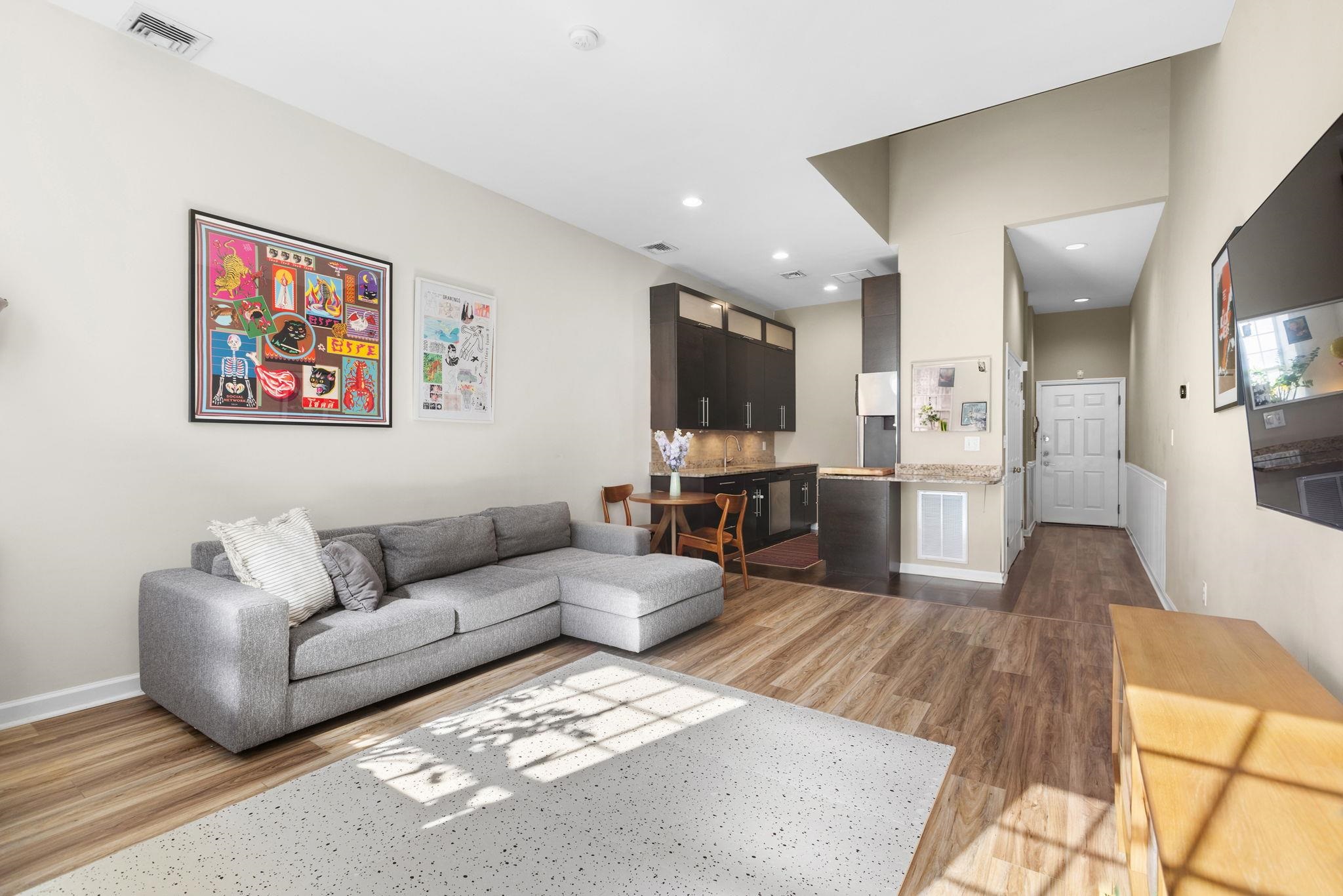 222 Clinton Street, Unit 13 Hoboken, NJ 07030 - Photo 3 of 16 a living room with furniture and a flat screen tv