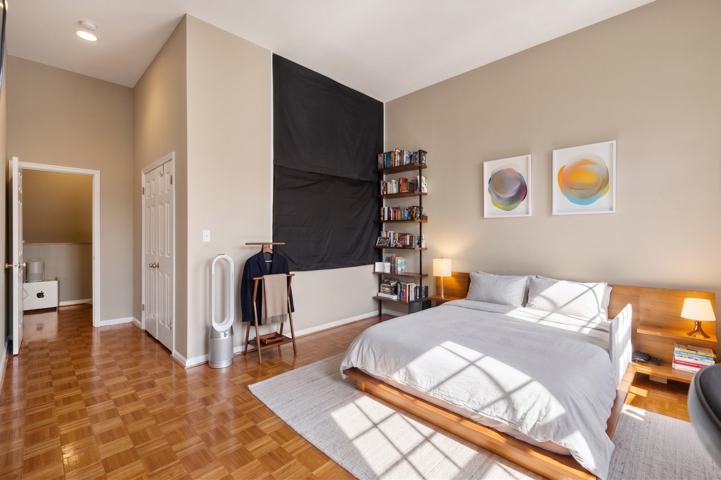 222 Clinton Street, Unit 13 Hoboken, NJ 07030 - Photo 5 of 16 a bedroom with a bed and wooden floor