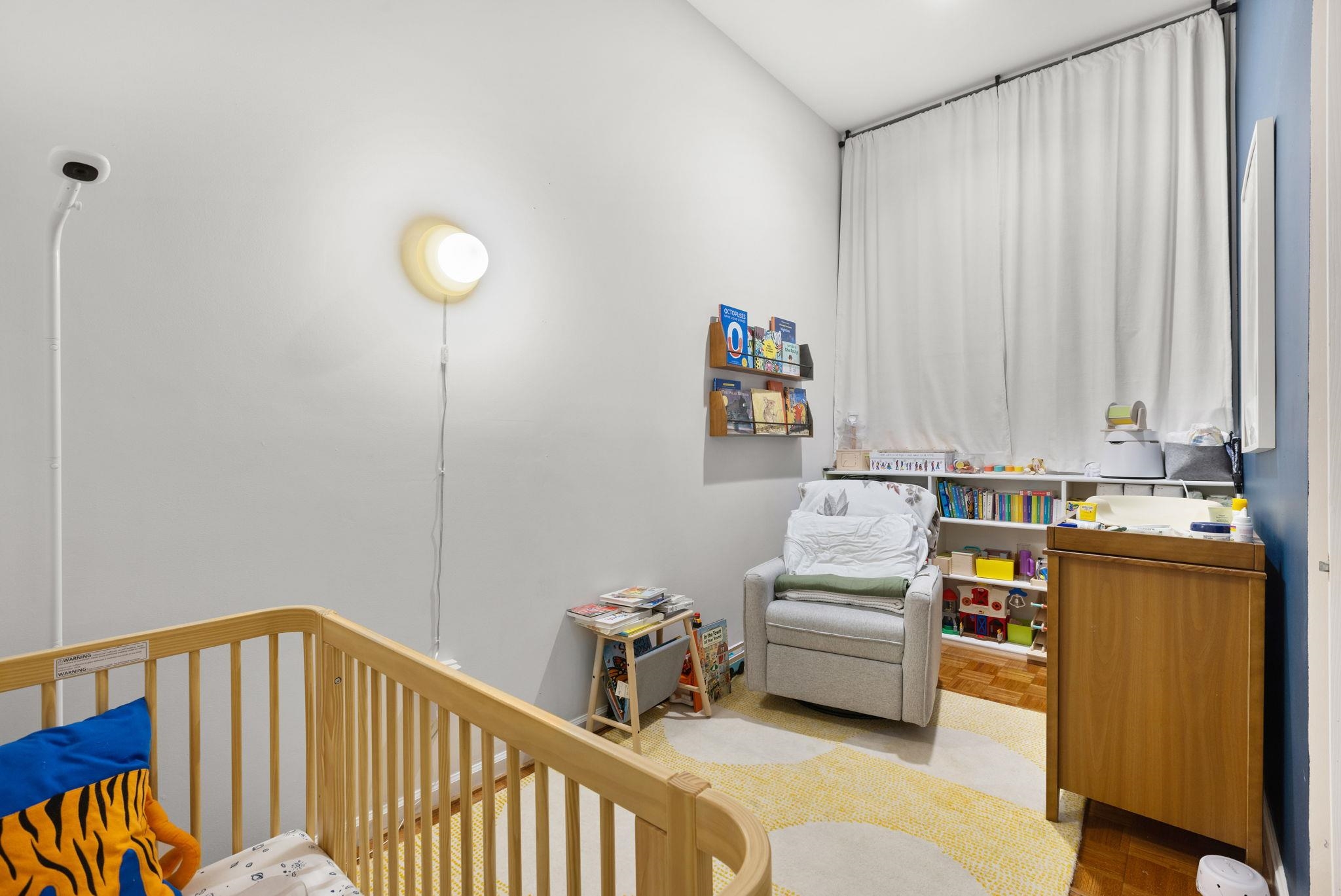 222 Clinton Street, Unit 13 Hoboken, NJ 07030 - Photo 6 of 16 a bedroom with furniture and a book shelf