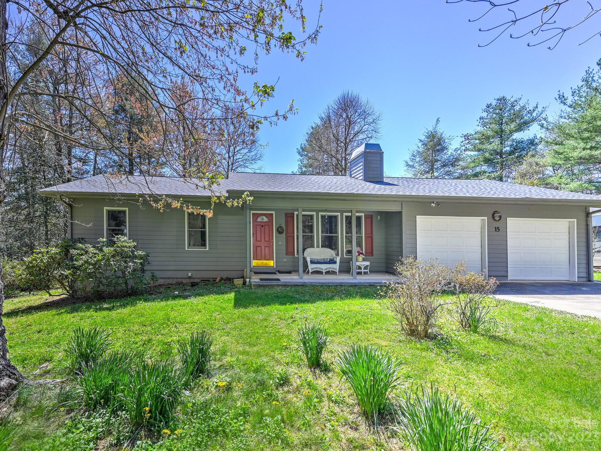 15 Maple Road Arden, NC 28704 - Photo 1 of 33 a front view of a house with garden and porch