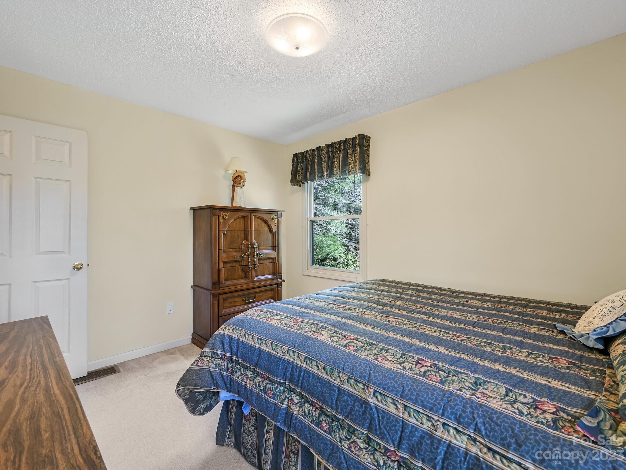 15 Maple Road Arden, NC 28704 - Photo 18 of 33 a bedroom with a bed and wooden floor