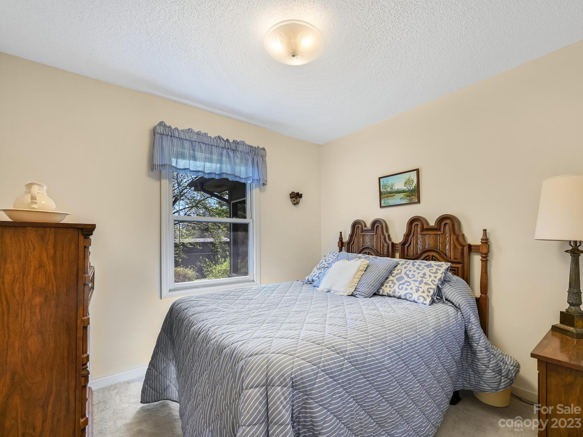 15 Maple Road Arden, NC 28704 - Photo 20 of 33 a bedroom with a bed and a window